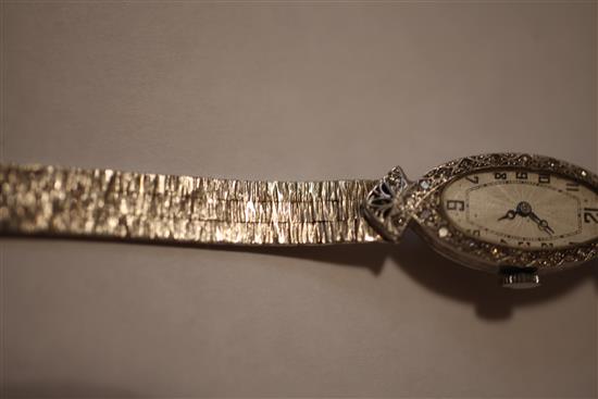 A ladys late 1920s 18ct white gold and diamond set cocktail watch,